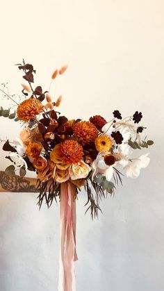 an arrangement of flowers in a vase on a table