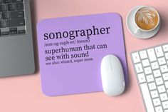 a mouse pad with the words songgrapher on it next to a computer keyboard