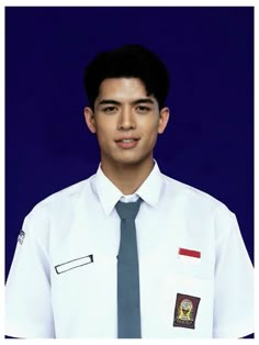 a young man wearing a white shirt and tie with badges on his shirtshirt