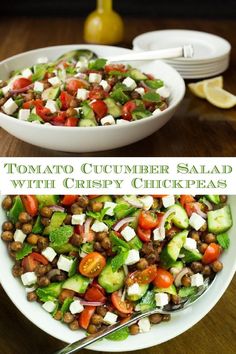 a salad with cucumber, chickpeas and tomatoes in a white bowl