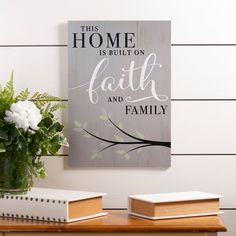 this home is built on faith and family sign with flowers in vase next to it