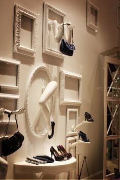 there are many shoes and purses hanging on the wall