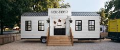 a tiny house with stairs leading up to it