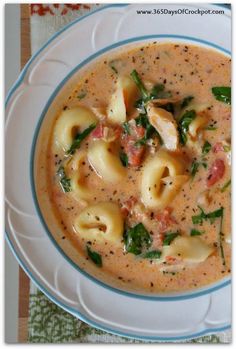 a bowl of soup with pasta and spinach