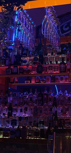 the bar is filled with many different kinds of liquor bottles and glasses on top of shelves