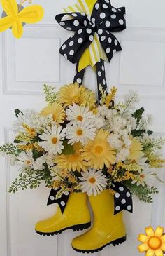 a bouquet of daisies and yellow boots hangs on the front door, decorated with black and white polka dots