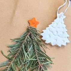 an ornament shaped like a christmas tree next to a pine cone and star