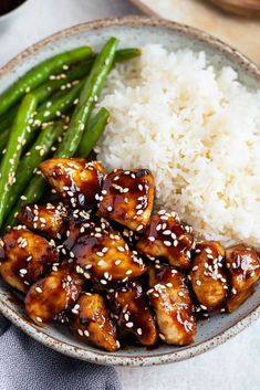 a plate with rice, green beans and chicken on it