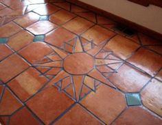 a bathroom floor that has been painted with different colors and designs on it, including the sun