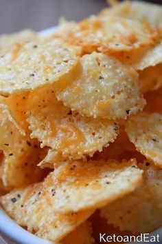 a bowl filled with cheesy crackers on top of a table