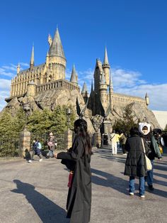 people are standing in front of hogwarts castle