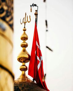 a flag is flying on top of a building with a gold dome and two spires