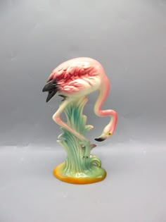 a glass figurine of a flamingo standing on its hind legs