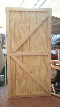 a large wooden door sitting on top of a brick floor