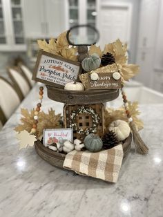 a table topped with a basket filled with fall decorations