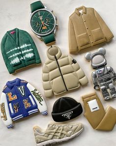 many different items are laid out on the table together, including jackets and hats to match