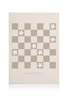 a white and gray checkered board with flowers on the side, in front of a white background