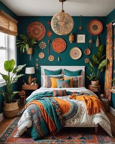 a bedroom decorated in teal, orange and white with lots of hanging plates on the wall