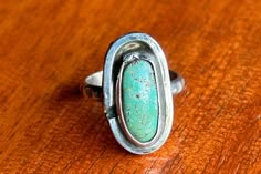 I absolutely adore the color on this turquoise stone. This has a beautiful slight green tint to it. The main photo is very accurate to the color. In more direct bright light it appears more blue which you can see in one of the other photos I posted.  This ring measures a 3.75 on my ring mandrel. You can tell it's hand made as it has some imperfections but I think they really make it stand out and enhance its beauty! The band is sturdy and well shaped. The face of the ring measures about 3/4" from top to bottom and 3/8" at its widest.  This ring is not marked with metal purity but I tested and it tested as sterling silver.  Please see all photos and if you have additional questions please message me! Thank you for looking! Silversmith Rings, Silversmithing Jewelry, Ring Mandrel, I Need Money, Like Someone, Copper Ring, Copper Rings, Turquoise Rings, Coastal Cowgirl