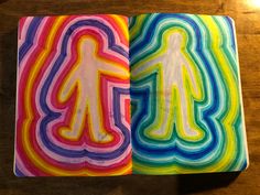 an open notebook with colorful paper cut out of it's body and the shape of a person