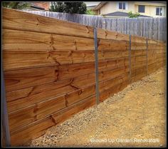 a wooden fence that is next to a house