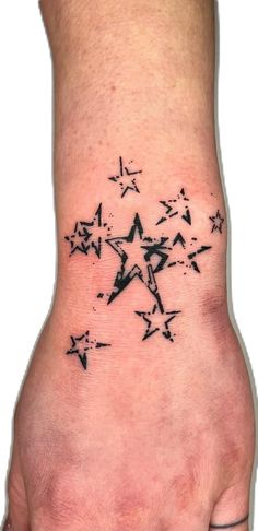 a person's foot with black ink and stars on the bottom of their toe