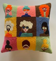 a colorful pillow with many different people on it's sides and one is made out of fuzzy material