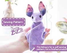 a hand holding a purple stuffed animal in it's left hand with the caption saying sewing pattern