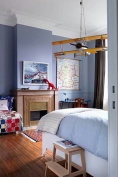 a bedroom with blue walls and wood floors