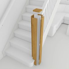 a white staircase with wooden handrails and banister