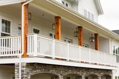 a white house with two balconies on the front porch