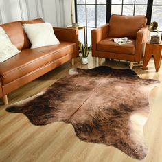 a living room with two couches and a cowhide rug