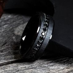 a black ring with white diamonds on it