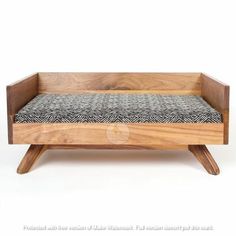 a wooden bench with a black and white cushion on the seat pad, against a white background