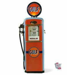 an orange and blue gas pump sitting on top of a white floor next to a sign that says gulf