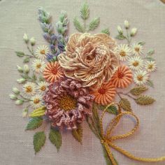 a close up of a piece of cloth with flowers on it and a ribbon in the middle