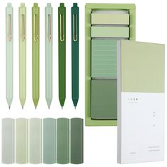 a set of four green and white pens, two lined notebooks and one plain notepad