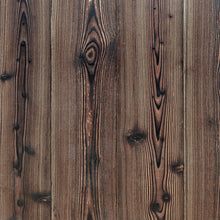 the wooden fence is brown and has vertical planks