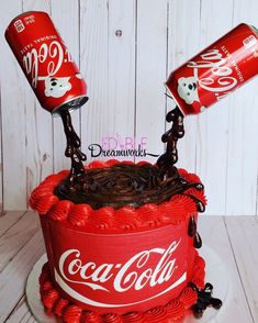 a cake decorated with coca cola cans and chocolate curls