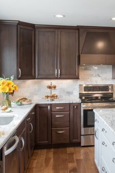 a kitchen with brown cabinets and white counter tops