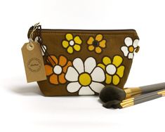 "This brown floral makeup or cosmetic bag is handmade using genuine 1970s vintage fabric. A small piece of vintage trim is sewn in the seam.  It is fully lined with yellow cotton fabric and closes with a zipper It is perfect for your makeup items, a small toiletry bag, or anything you want to store in it. approximate dimensions:  height: 14 cm - 5.5\" width: 23 cm top - 16cm bottom | 9\" top - 6\" bottom depth: 8 cm - 3 1/8\" Because this is a handmade item, the placement of the pattern may vary slightly. All products are made by hand in my studio in The Netherlands from beautiful, unusual, and vintage fabrics. If You want more info, photos, and answers to Your questions, feel free to contact me. Shipping costs are included and based on REGISTERED shipping with Track & Trace. http://www.El Yellow Cotton Fabric, Floral Makeup, Retro Makeup, Makeup Items, 70s Retro, Toiletry Storage, Brown Floral, Vintage Fabrics, Vintage Fabric