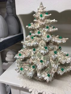 a white christmas tree sitting on top of a table