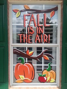 a window with fall is in the air written on it