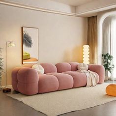 a living room with pink couches and white rugs on the floor next to a large window