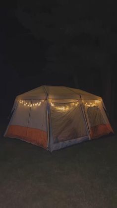 a tent is lit up with fairy lights