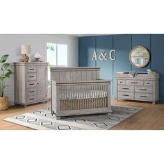 a baby crib and dresser in a room with blue walls