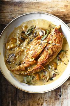 a white plate topped with chicken covered in gravy