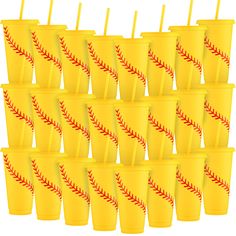 a bunch of yellow cups with straws in them that have baseball designs on them