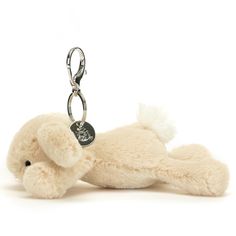 a stuffed animal keychain with a tag on it