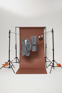 a brown backdrop with clothes hanging on it